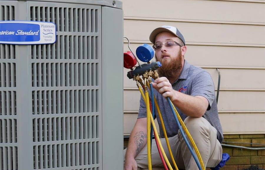 AirWorks Cooling and Heating, LLC technician working on an AC unit